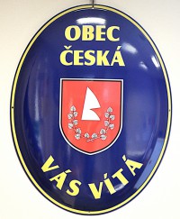 Oval welcome sign with a coat of arms and the name of a village/town/township