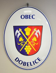 Oval welcome sign with a coat of arms and the name of a village/town/township