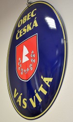 Oval welcome sign with a coat of arms and the name of a village/town/township